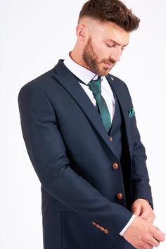 As seen on Emmerdale's Danny Miller, this Max suit will do just the job. The hints of tan will distinguish it from the sea of uninspiring suits on your commute and the complementary camouflage print pocket square adds a modern edge. It is classy, sophisticated and refined, all that a good suit should be. Features Slim fit Single-breasted Notch lapel Single back vent Four button cuff Double button blazer fastening Waistcoat adjuster straps Complimentary pocket square Functional inside and outside Mens Navy Suit, Navy Blue Blazer, Navy Suit, Looking Dapper, Blue Trousers, Camouflage Print, Fitted Suit, Printed Blazer, 3 Piece Suits