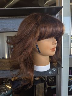 a mannequin's head in a store window