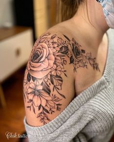 a woman with a flower tattoo on her shoulder