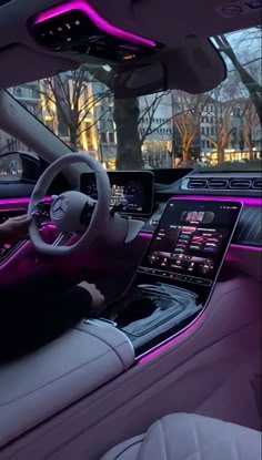 the interior of a car with purple lights