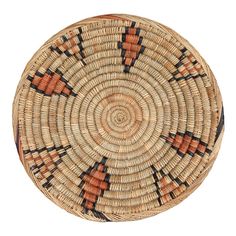 a round woven basket with an orange and black design