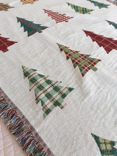 a quilted christmas tree is displayed on the bed