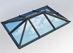 the sky is reflected in the window of this modern building's glass roof structure