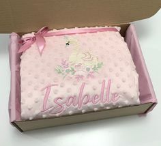 a cake in a box with the name esplelle on it and a pink bow