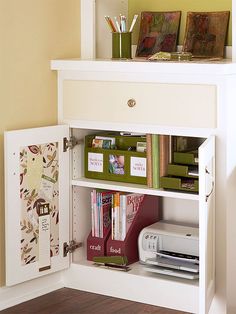 a white book shelf with books and other items on it in a home office area