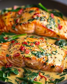 two salmons covered in yellow sauce and spinach