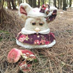 a stuffed animal wearing a dress in the woods