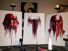 three paintings with red paint on them and one has a darth vader helmet