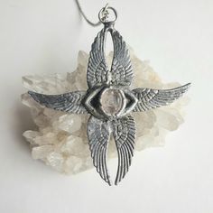 This new design was inspired by one of the biblical angels described in the bible called a Seraphim.  Biblical angels are described very different to the way our culture has them appear.  The Seraphim angel has two wings covering the face, two covering feet and two that fly. Each pair of the wings has a different purpose and meaning. Two of the six wings conceal the angel's face; two cover the feet; and the remaining two fly. The four wings used to cover serve to express humility before God. Thi Seraph Wings, Seraphim Headpiece, Seraphim Necklace, Cross With Wings Necklace, Silver Fantasy Wing-shaped Jewelry, Seraph Angel, Clear Quartz Necklace, Angel Face, Quartz Necklace