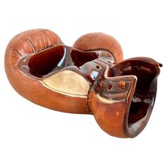 an old pair of brown leather shoes sitting on top of each other