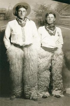 two men dressed in animal costumes standing next to each other with hats and scarves on