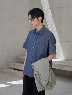 This is lightweight comfortable oversized shirt made from cotton chambray that will create natural washed look by wearing like denim. It's versatile for both casual and classic styling wearing as solo or under the jacket.- Collared neck- Button fastenings - One chest pocket and pencil holder- Short sleeves- Curved hem- Oversized fit Casual Solid Shirt With Roll-up Sleeves, Cotton Tops With Roll-up Sleeves, Summer Chambray Denim Shirt, Indigo Cotton Short Sleeve Shirt, Classic Indigo Shirt For Summer, Oversized Cotton Shirt With Roll-up Sleeves, Casual Denim Shirt For Summer, Short Sleeve Washed Blue Shirt With Pockets, Casual Denim Blue Top For Everyday