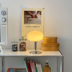 a table with books and a lamp on it