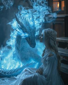 a woman in white dress sitting next to a blue fire breathing dragon on a bench