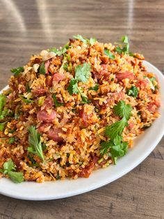 a white plate topped with rice and vegetables