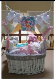 a white basket with baby items hanging from it