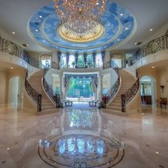 the inside of a house with stairs and chandelier