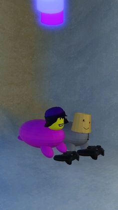 two lego figures are sitting in the middle of a room with blue and purple lights