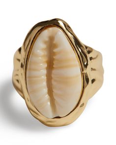 This ring features a cowrie shell encased in a hammered 16K gold-plated bezel. Cowrie shell pendant Hammered 16K gold-plated bezel 50% Brass 50% Resin The Shell Ring is styled with the Pearl Necklace With Jasper Pendant, Sport Bikini Top, and the Adjustable Ruched Bottom. Gold Shell Jewelry, Sport Bikinis, Puka Shell, Shell Ring, Sugar Cravings, Conch Shell, Jasper Pendant, Shell Jewelry, Cowrie Shell