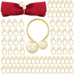 a set of jewelry with pearls and a red bow