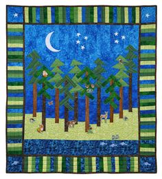 a quilted wall hanging with trees and animals in the woods at night, on a blue background