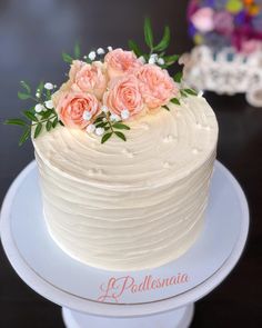 a white cake with pink flowers on top