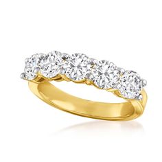 a yellow gold ring with five diamonds