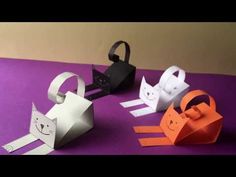 three different types of paper animals on a purple surface