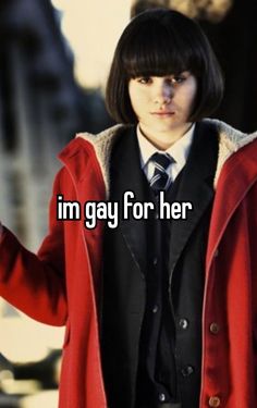 a woman in a red coat and tie with the words i'm gay for her