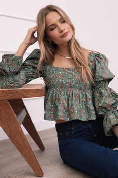 DETAILS   The Kenny Top in Green Paisley Floral is a chic addition to any wardrobe. Its cropped length pairs perfectly with high-waisted jeans or skirts, making it a versatile piece for various outfits. The square neckline adds a trendy touch, while the long sleeves with frill style cuffs and the shirred detail on the sleeves give it a unique, stylish flair.    cropped length  square neckline  long sleeves with frill style cuffs   shirred detail on sleeves  back shirred panel  back tie close det Wedding Swimwear, Satin Dresses Long, Satin Dresses Long Sleeve, Black Tie Wedding Guests, White Dress Shoes, Green Paisley, Essential Dress, Resort Dresses, Crop Top Tees