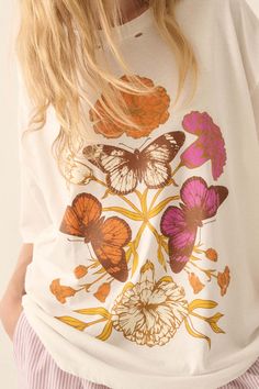 Distressed, garment washed graphic t-shirt. Torn and distressed detailing at neckline, cuffs, and hem. Vintage-style butterflies and flowers graphic print. Round neckline. Short sleeves. Drop shoulder. Oversized fit. 100% Cotton. Imported top designed and printed in LA. Model wears size S. White Vintage Print T-shirt For Spring, Oversized White Floral Print T-shirt, White T-shirt With Vintage Print For Spring, White Tops With Vintage Print For Spring, White Top With Vintage Print For Spring, White Butterfly Print Top For Fall, Spring Graphic Tee With Butterfly Print, White Bohemian T-shirt For Spring, Vintage Butterfly Print T-shirt For Summer