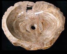 a wooden bowl shaped like a tree stump with a hole in the center that has been carved into it