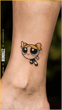 a small cartoon character tattoo on the ankle