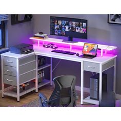 a computer desk with two computers on it