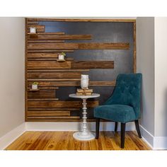 a blue chair sitting in front of a wooden wall