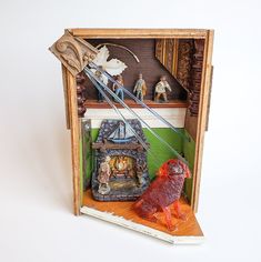 a wooden box with some figurines in it