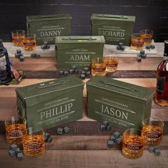 six bottles of whisky and glasses on a wooden table