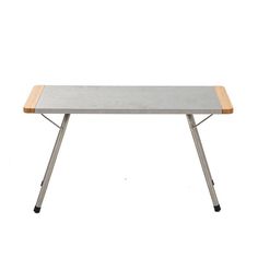 a wooden table with metal legs and a gray top on a white background in front of a white backdrop