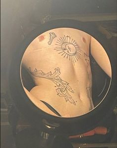 a man's back with tattoos in a bowl