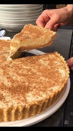 a person cutting into a pie on top of a white plate