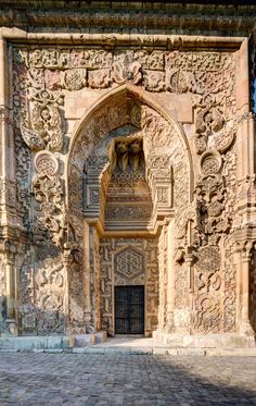 the entrance to an old building with carvings on it