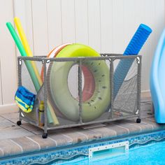 a swimming pool filled with lots of different types of toys and items in a metal container