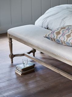 a wooden bench sitting on top of a hard wood floor