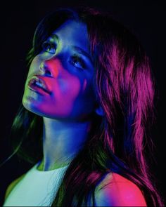 a woman with long dark hair and neon lights