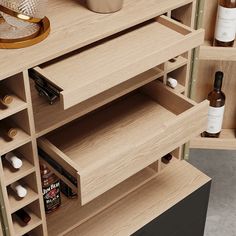 a wooden cabinet with bottles and other items on it's shelfs in a room