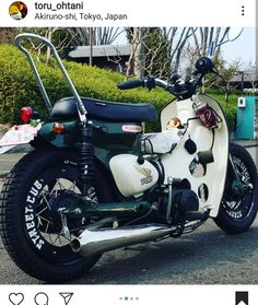 a white and black motorcycle parked in a parking lot