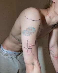 a man with a cross tattoo on his arm