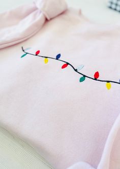 Embrace the joy of the holiday season with our Christmas Lights Embroidered Sweatshirt. This beautifully embroidered piece combines comfort and festive flair, making it the perfect addition to your winter wardrobe! Unmatched Comfort: Made from a cozy blend of 50% cotton and 50% polyester, this sweatshirt is designed to keep you warm and comfortable all season long. Stylish Design: Featuring vibrant, high-quality heat transfer embroidery, this shirt captures the essence of Christmas and adds a ch Hand Embroidered Christmas Sweatshirt, Christmas Catalogs, Embroidered Sweatshirt, Holiday Lights, Embroidered Sweatshirts, Christmas Sweatshirts, Winter Wardrobe, Stylish Design, Christmas Lights