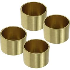 four brass metal cups sitting next to each other