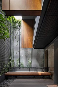 a wooden bench sitting next to a tall building